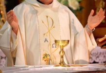 Priest Smoking Meth in Church Shocks Town A priest holding a golden chalice during a religious ceremony