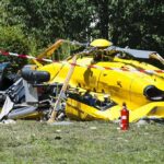 yellow helicopter crash scene on grassy field