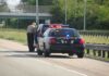 Trump Torches ICE Pause After Deadly Traffic Stops Police officer conducting a traffic stop on a highway