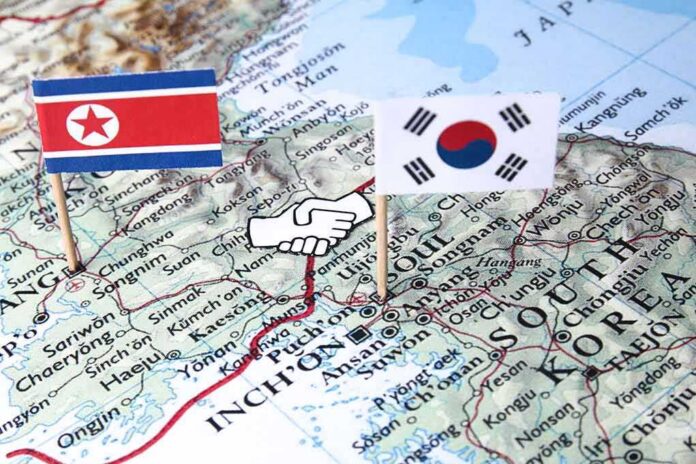 shutterstock_1078499288 Map of Korean Peninsula with North and South Korean flags and handshake icon