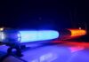 Police car light bar flashing blue and red at night