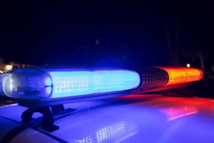 shutterstock_1168252924 Police car light bar flashing blue and red at night