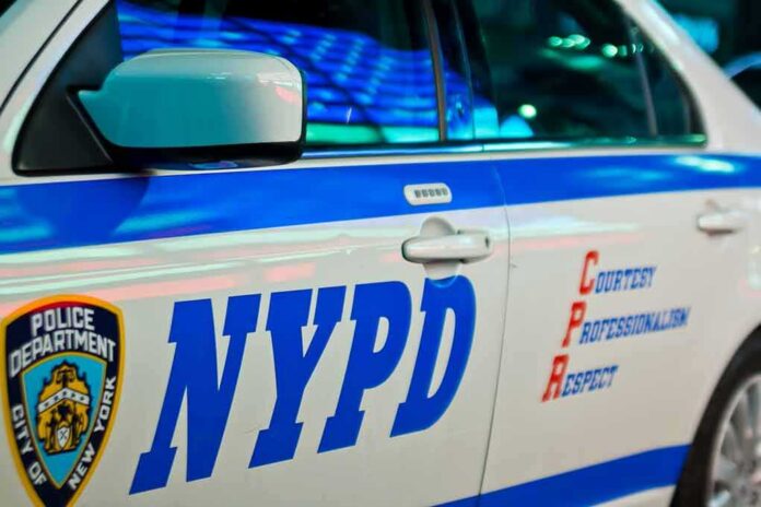 shutterstock_1396574180 NYPD patrol car side with blue stripe and door lettering
