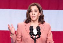woman speaking at a podium with microphones
