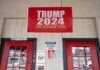 Trump Store BANKRUPT – Closes Down Immediately red political banner above two red doors on a storefront