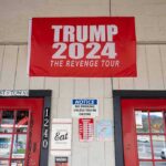 Trump Store BANKRUPT – Closes Down Immediately red political banner above two red doors on a storefront