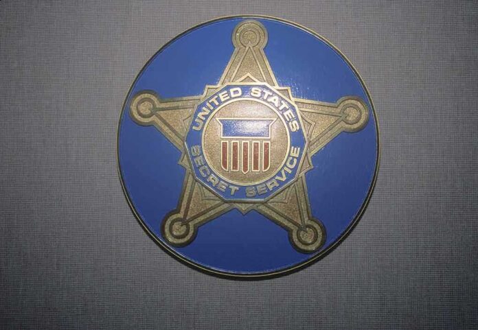 shutterstock_270055817 United States Secret Service badge emblem on blue background