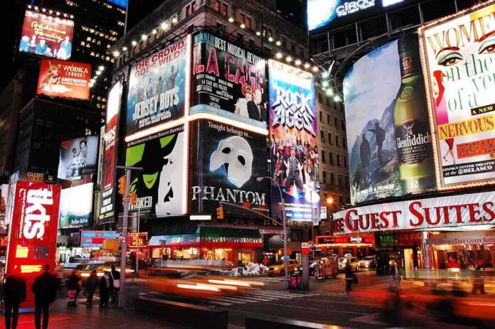 Vibrant night scene of Times Square filled with theater advertisements and neon lights