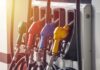 Global Fuel Protests Erupt World Wide Fuel pump nozzles in multiple colors at a gas station