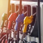 Fuel pump nozzles in multiple colors at a gas station