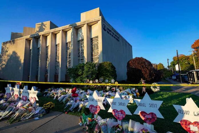 Synagogue exterior with memorial flowers and star-shaped tributes on lawn
