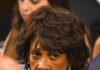 older woman with short wavy hair looking intently to the side