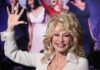 Tennessee Honors Dolly Parton With Touching Gesture blonde woman waving at a red carpet event