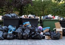 Woman GUILTY – Murders Newborn in Dumpster Overflowing dumpsters with piles of trash bags and cardboard
