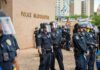 Teddy Williams and Carlos Hyde among police officers in riot gear outside police headquarters