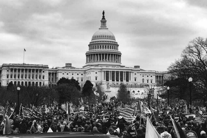 shutterstock_1888600195 U.S. Capitol building with large crowd and flags