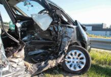 Crashed car with severe side damage and deployed airbag