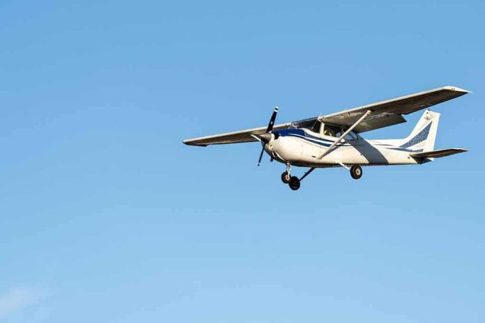 shutterstock_2136488743 Single-engine airplane flying against clear blue sky
