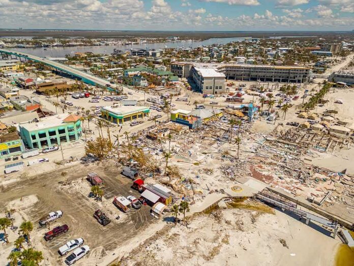 shutterstock_2208987255-1 Aerial view of coastal town with widespread storm damage