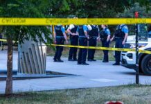 NEW Super Drug Floods Street – Teens DEAD police officers stand behind caution tape at a park scene