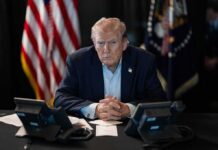 Trump Breaks 62-Year Tradition During Xi Meeting Donald Trump seated at a table between two desk phones