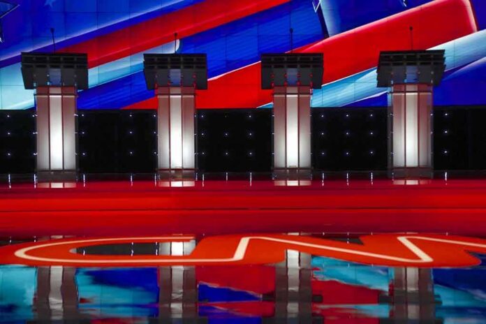 shutterstock_353120126-1 Debate stage with four empty podiums and bright red and blue backdrop