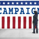 Democrats Panic: Disgraced Candidate Accused AGAIN! Man in suit writing on large campaign banner with stars and stripes