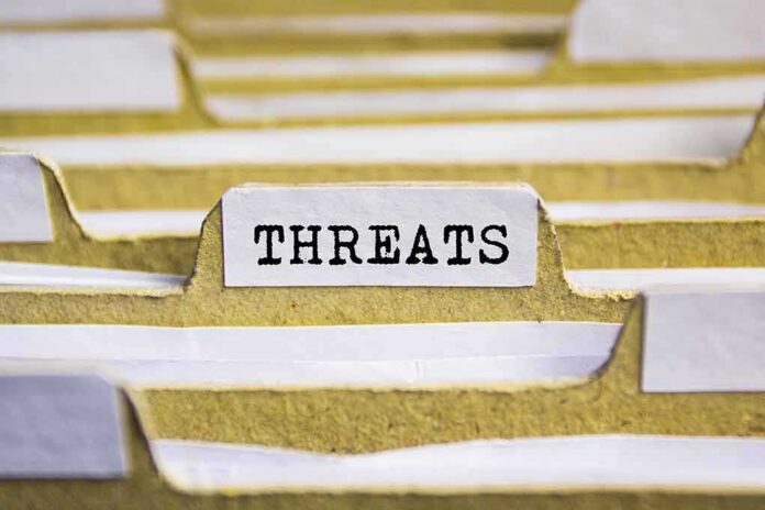 index tab labeled threats in a filing organizer