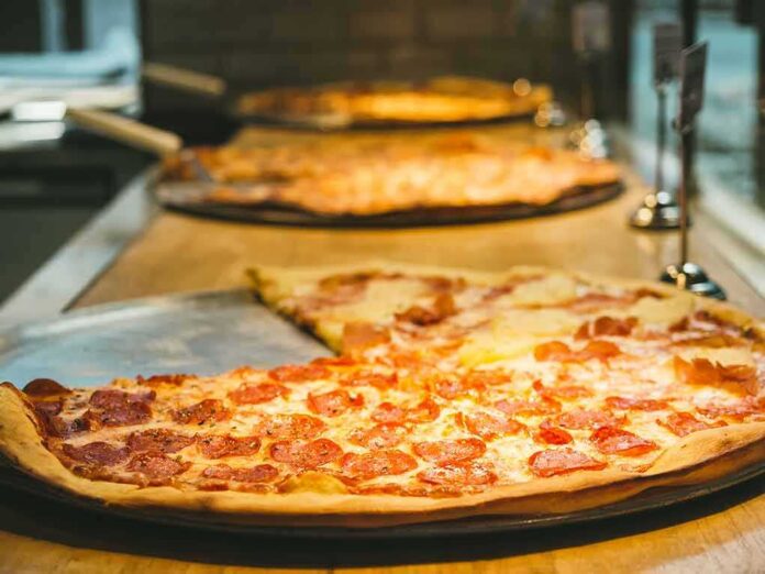 Pepperoni pizza slices on metal trays