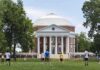 Students playing on a lawn in front of a domed neoclassical building