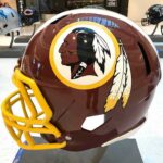NFL Team Revives Former Name Six Years After Abandoning It maroon football helmet with yellow facemask on display