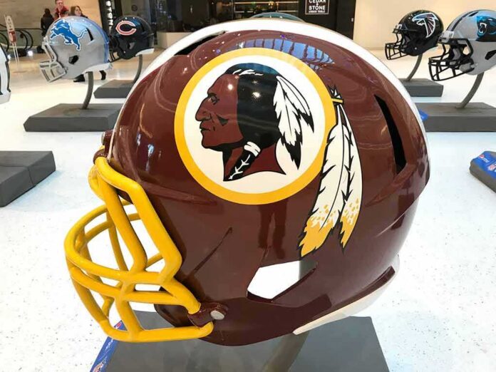 maroon football helmet with yellow facemask on display