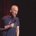 Liberal Talk Show Host Vows To Vote Republican in Upcoming Elections Bill Maher performing stand-up with a microphone on stage