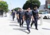 Police officers walking in formation on a city sidewalk