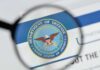 magnifying glass focusing on U.S. Department of Defense seal