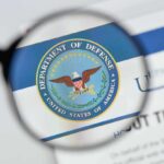 Pentagon Power Play: New Fortress Bidding War magnifying glass focusing on U.S. Department of Defense seal