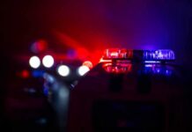 Police car light bar flashing red and blue at night