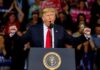 Trump Orders Chinese Company Purge – Get Them Out! Donald Trump speaking at a rally podium with arms raised