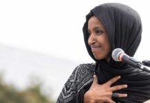 What Ilhan Omar Directed Staffers To Do Is CRAZY! Ilhan Omar speaking at a microphone with hand on chest
