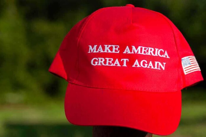 shutterstock_1466940743 Red baseball cap with political slogan and small U.S. flag patch