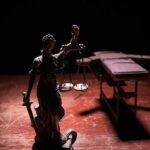 Christa Pike’s Troubling Recovery Following Botched Execution Lady Justice statue with scales in dramatic light beside an empty gurney