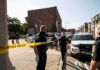 WILD Footage of Assassin’s Arrest Has Been Unsealed Police officers secure an urban street with yellow tape near patrol cars