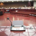 Hail Satan Prayer Shocks City Hall Conference microphone on a podium in a courtroom