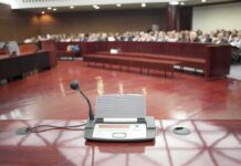 Hail Satan Prayer Shocks City Hall Conference microphone on a podium in a courtroom
