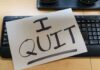 Paper note reading I QUIT on a computer keyboard