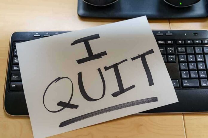 Paper note reading I QUIT on a computer keyboard