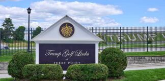 Entrance sign at a golf course with manicured shrubs