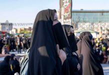 Female Iran Militia Leader Gunned Down At Home Women in black veils standing in a crowded outdoor gathering