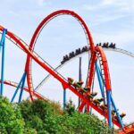 Theme Park Horror: One Dead, Several Injured Colorful roller coaster with riders on a sunny day