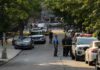 Pregnant Mom Among DEAD In Home Massacre Police officers secure a residential street with patrol cars and yellow tape